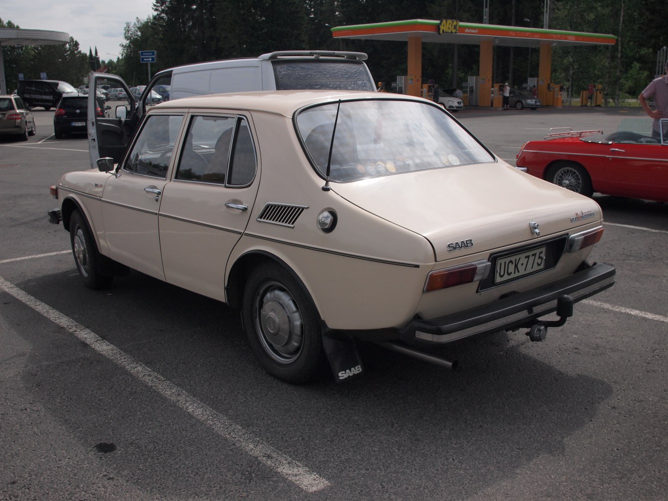 Rear and side profile of a classic Saab 99 sedan with distinctive rear window and trim.