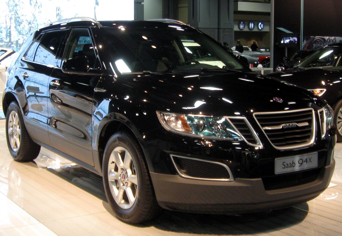 Front grille and side profile of a black SUV with alloy wheels