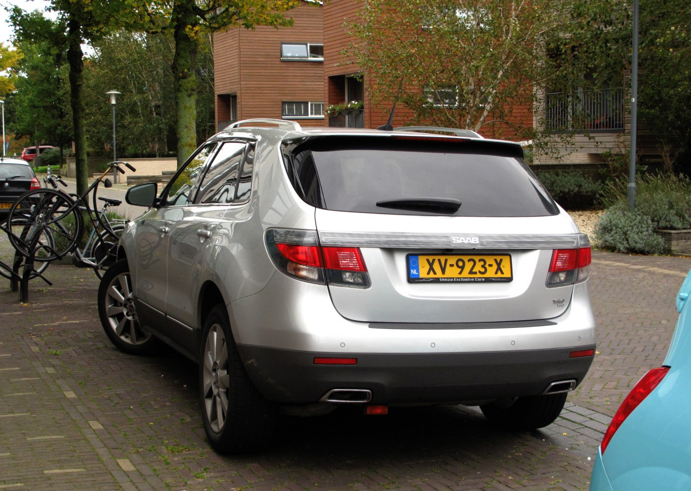 Silver SUV rear with horizontal tail lights and dual exhaust