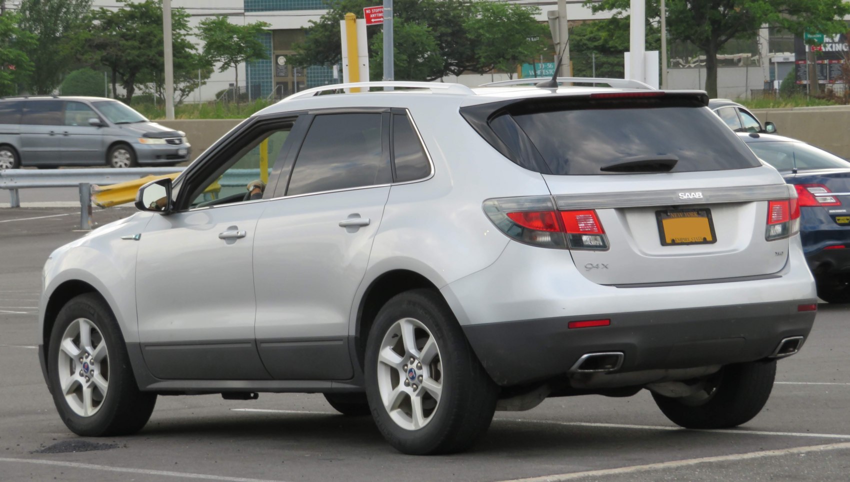 Silver SUV rear and side view with tinted windows and dual exhaust