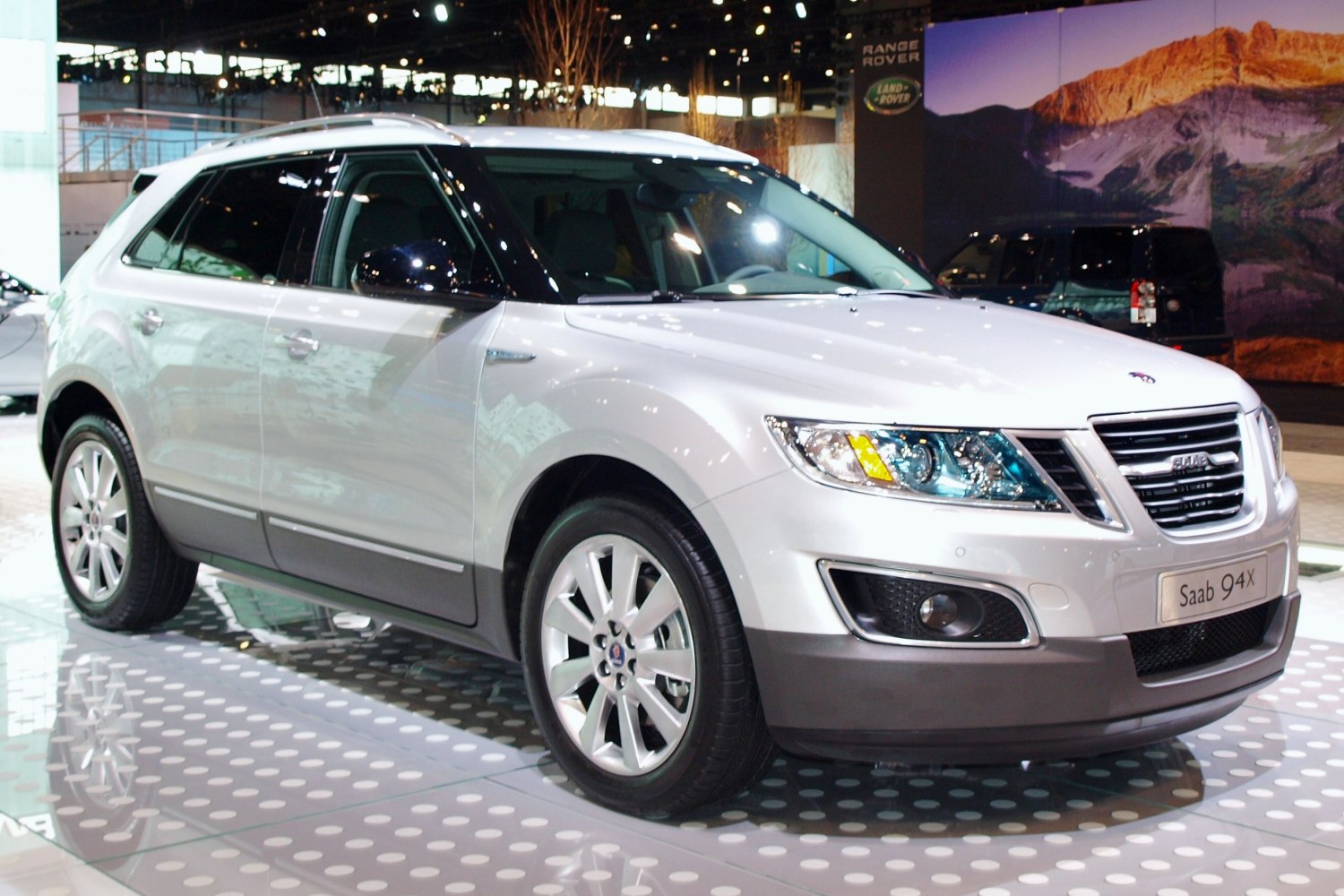 Front-side view of a silver SUV with distinct headlights and grille