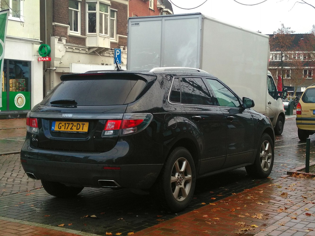 Rear view of an SUV with dark tinted windows and dual exhausts