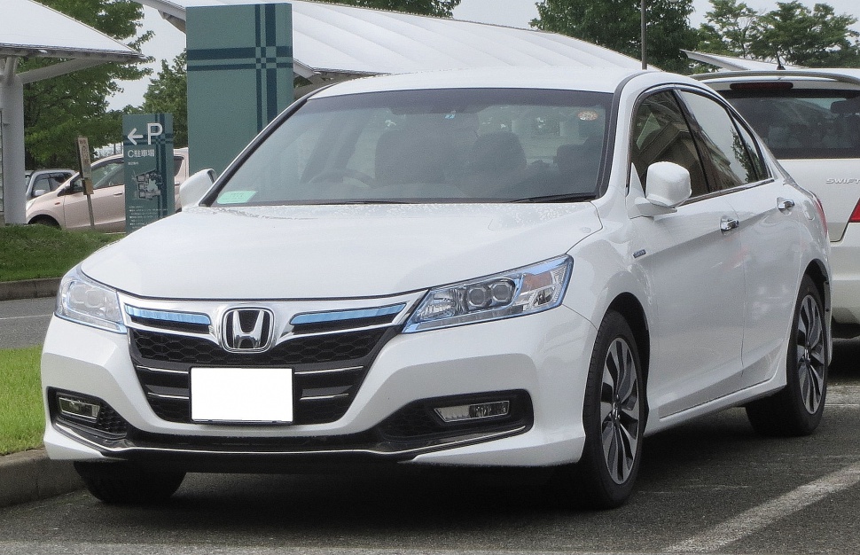 White mid-size sedan front with LED headlights and chrome grille
