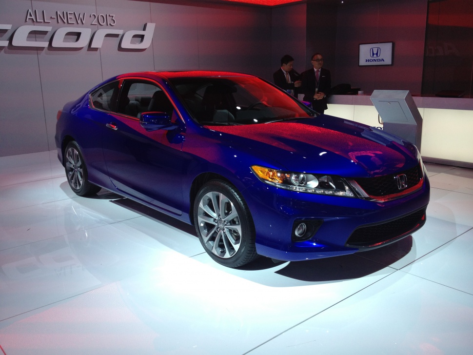 Front side view of a sleek compact coupe with alloy wheels and sporty design