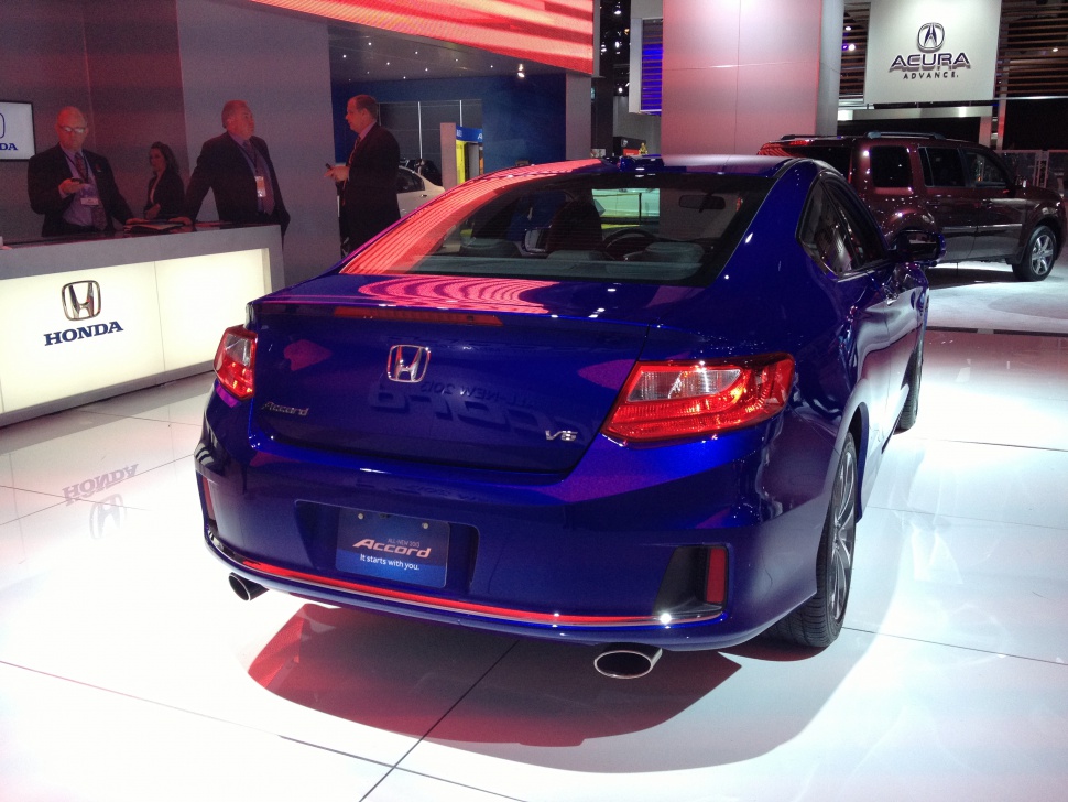Rear view of a mid-size coupe with V6 badge and dual exhausts