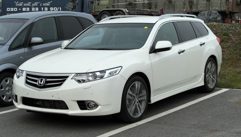 White facelift wagon with distinct headlights and alloy wheels front side view