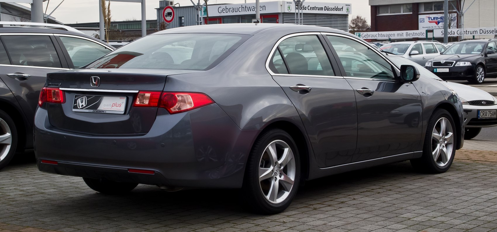 Rear and side view of sedan with alloy wheels and distinct tail lights