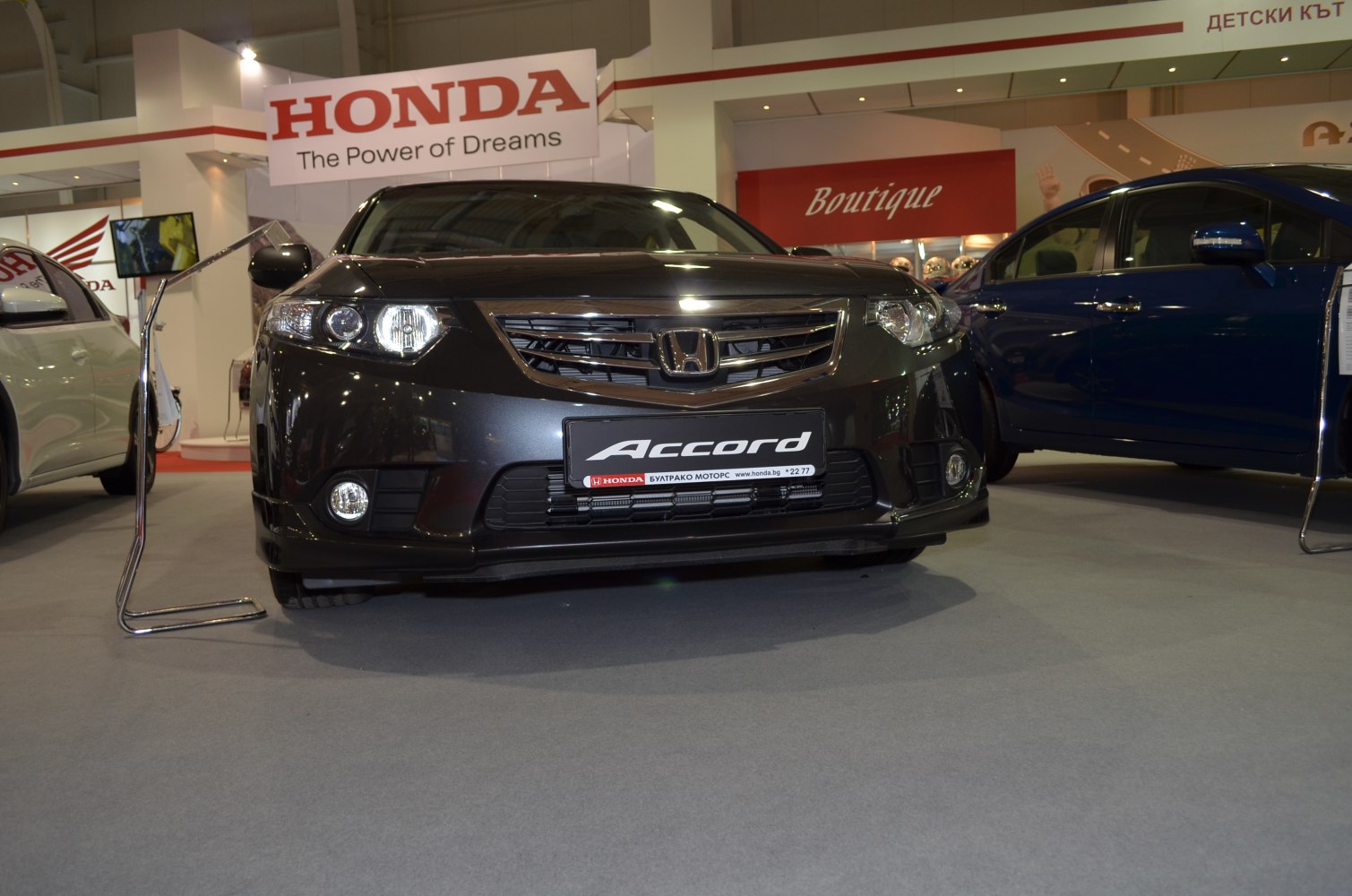 Front view of sedan with distinct headlights and grille