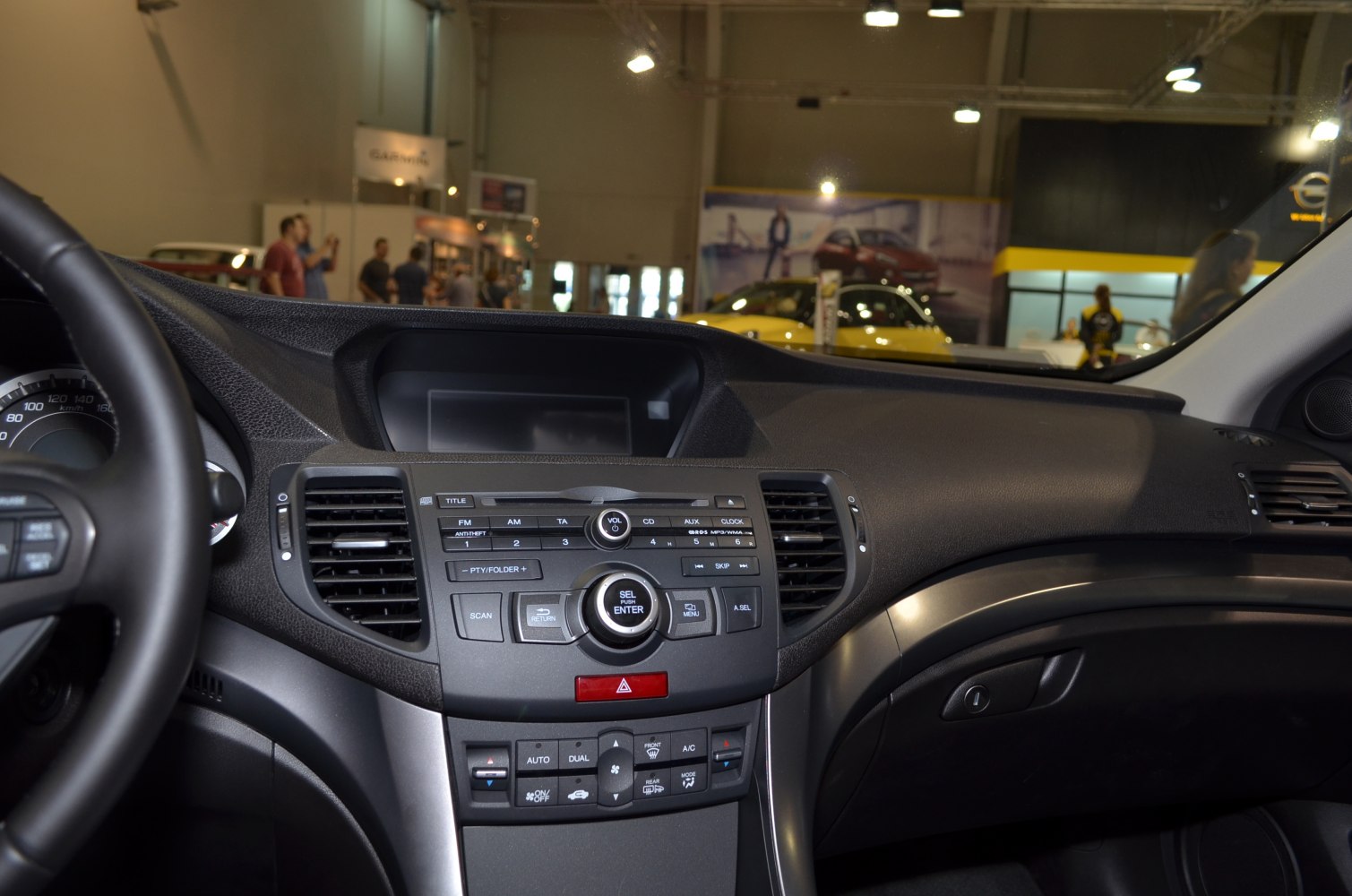 Dashboard control panel with audio and climate controls in a passenger car interior