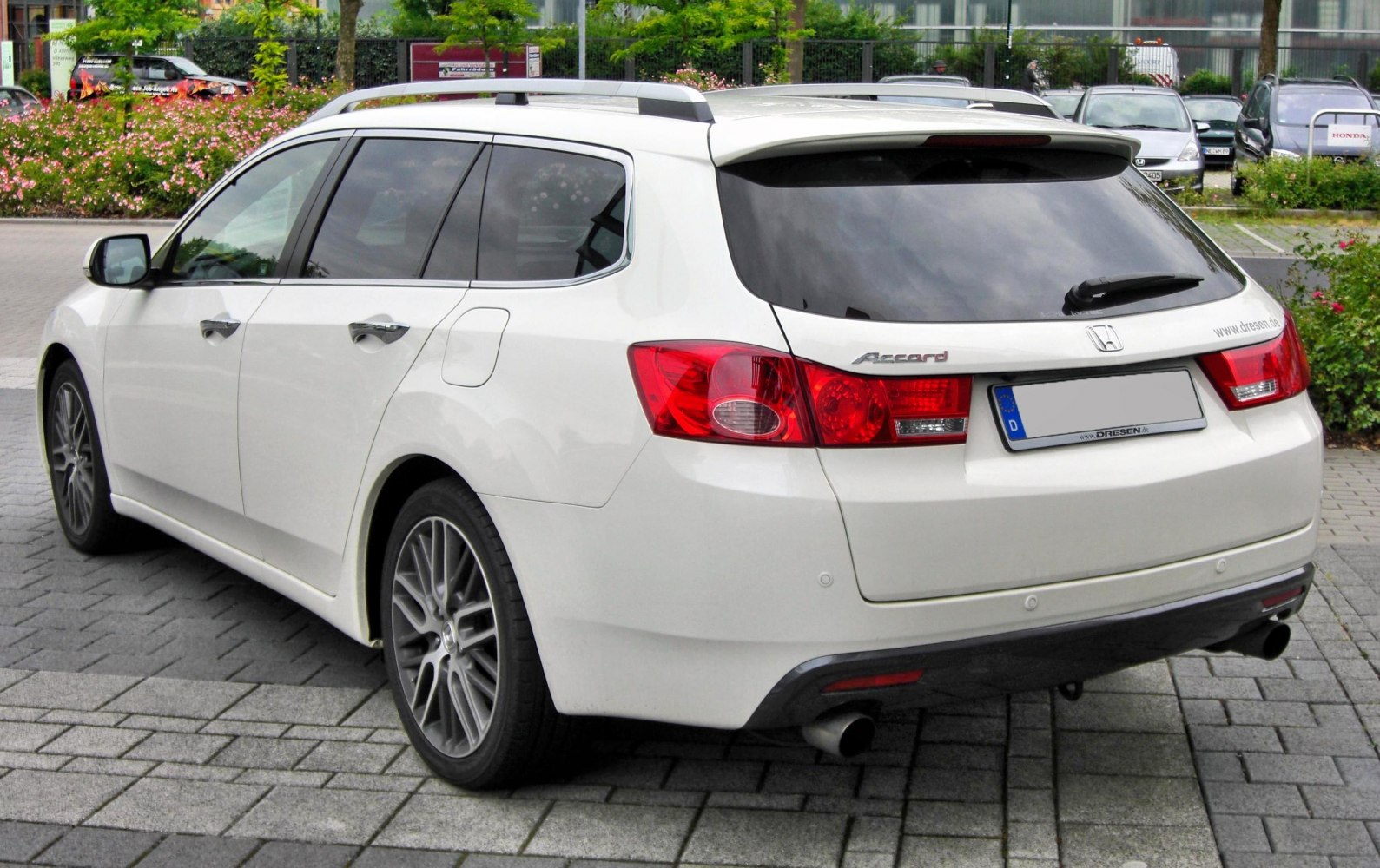 Rear-side view with tail lights and sporty alloy wheels of a station wagon