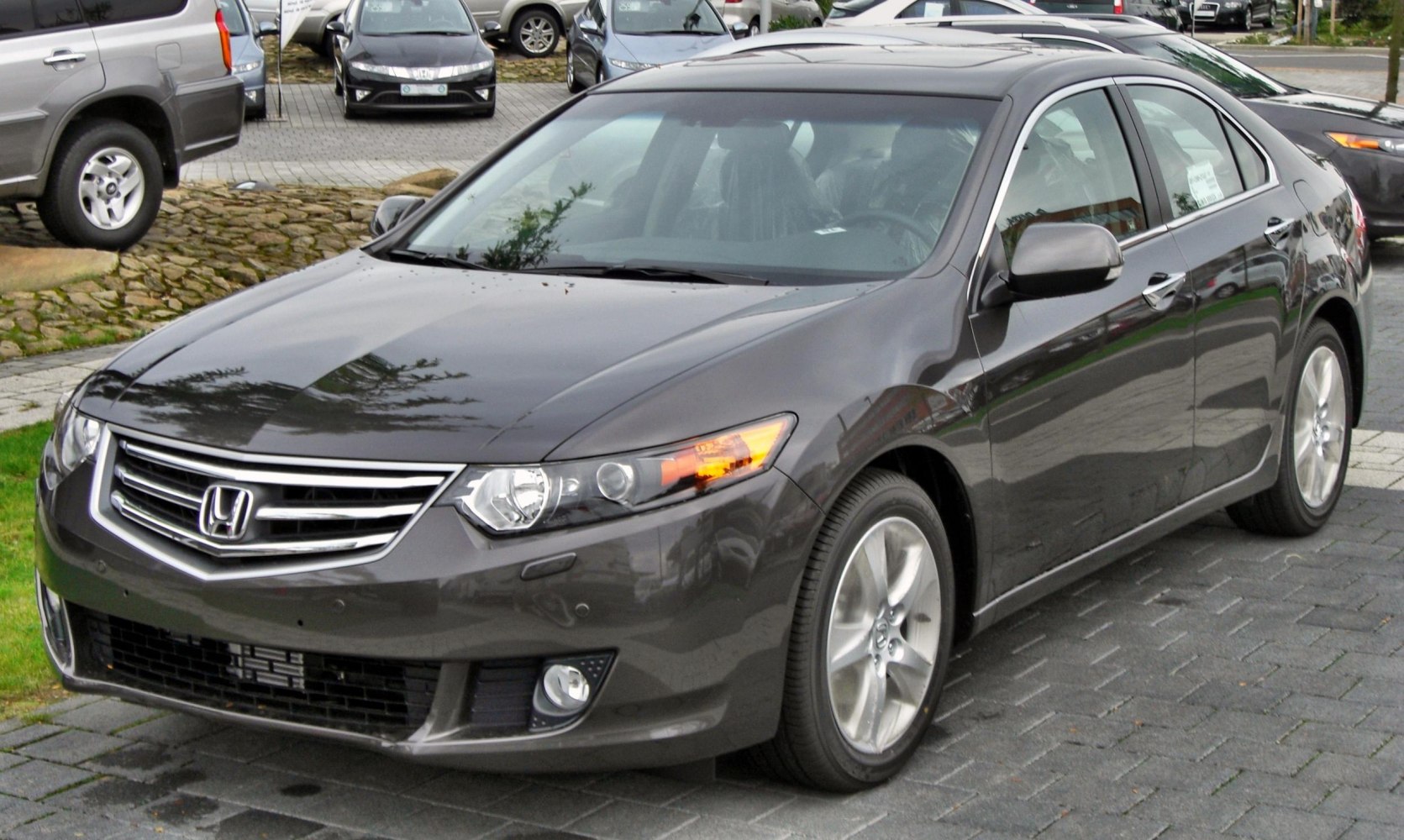Front three-quarter view of a modern sedan with alloy wheels and turn signal active