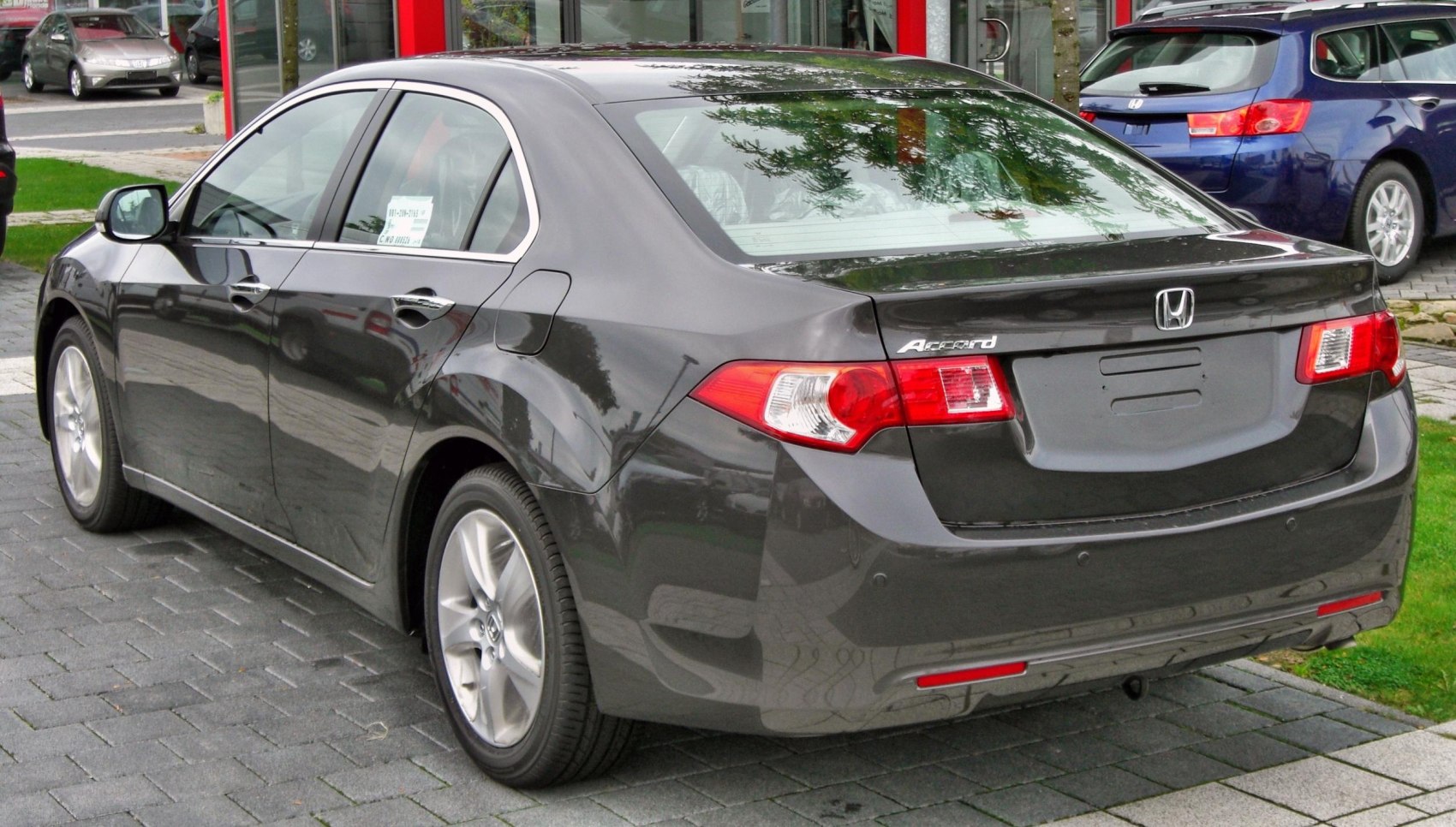 Rear and side view of a modern sedan with distinctive taillights and smooth body lines