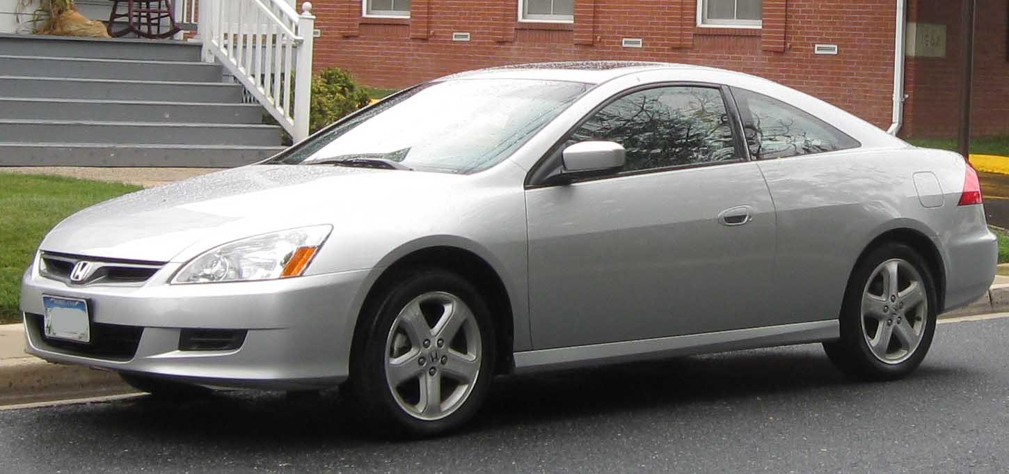 Silver two-door coupe with alloy wheels side profile