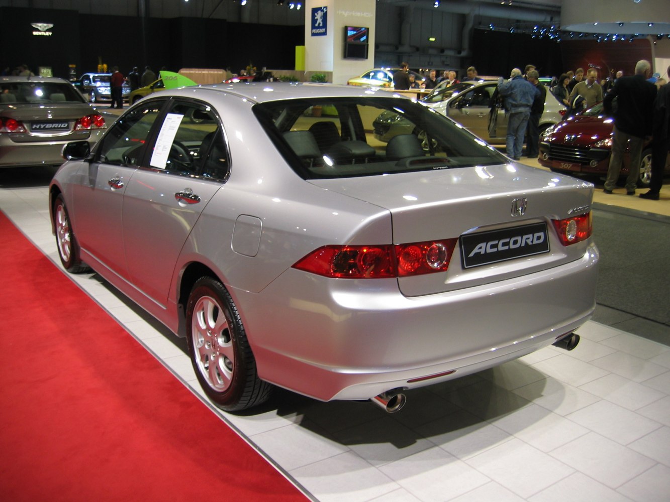 Silver sedan rear view with distinctive taillights and dual exhaust