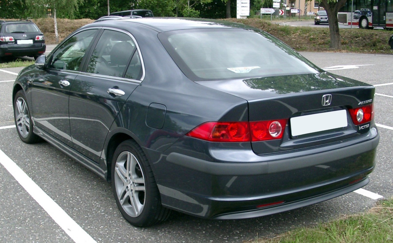 Rear side view with alloy wheels and red circular taillights
