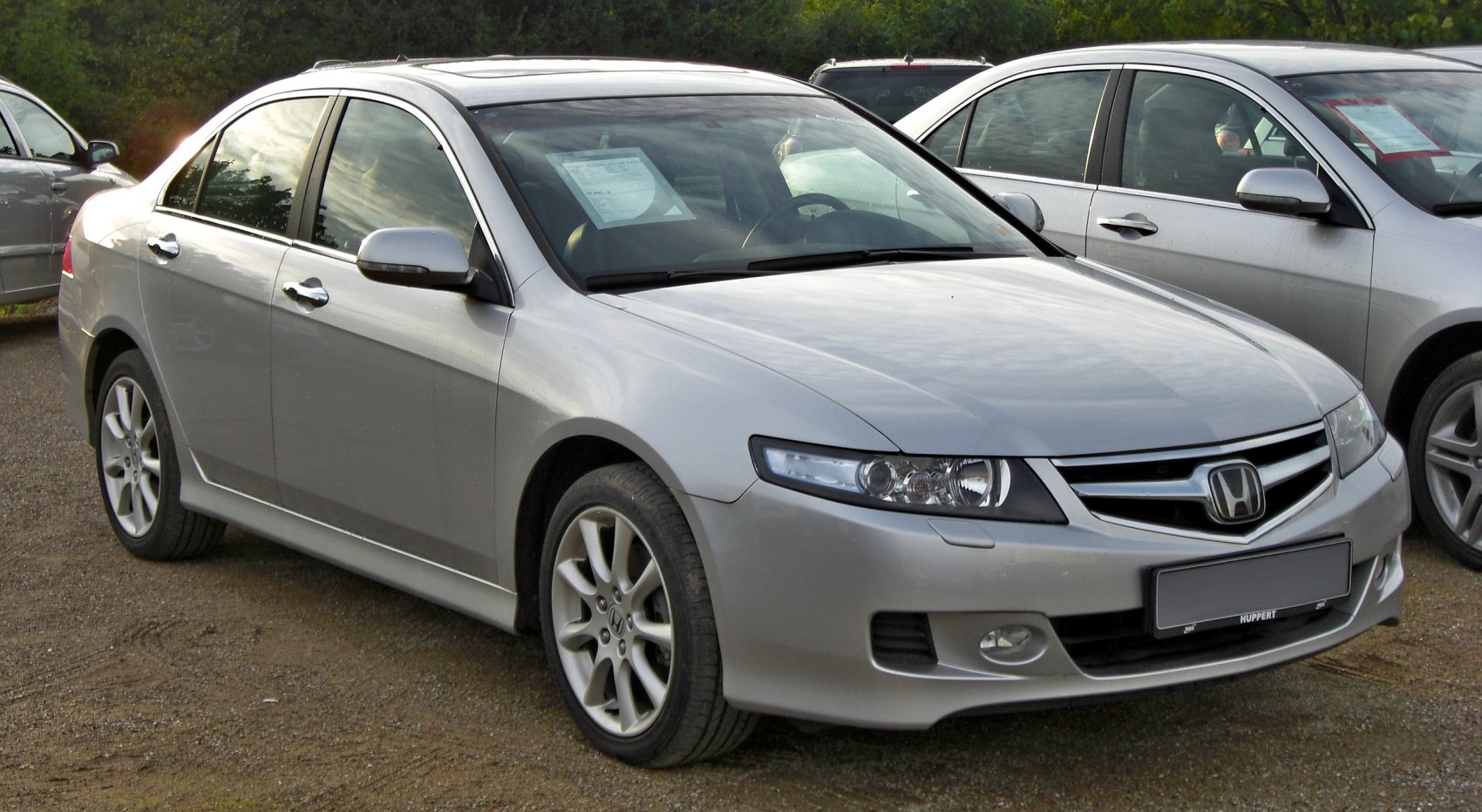Front-side profile and alloy wheels of a silver sedan