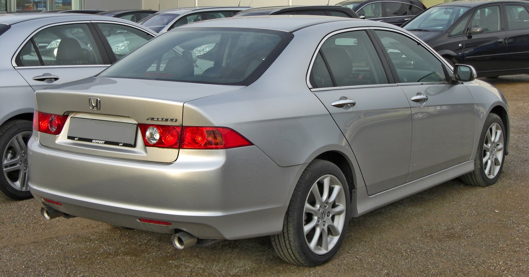 Silver sedan rear view with distinct tail lights and alloy wheels
