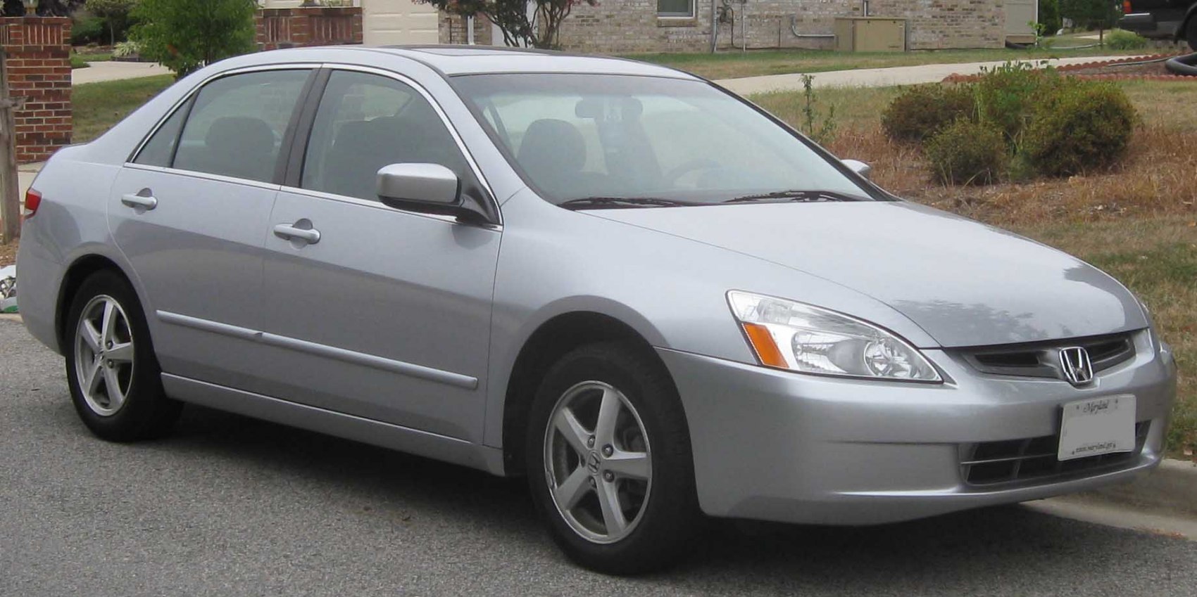 Silver midsize sedan with alloy wheels and sleek front-3/4 design