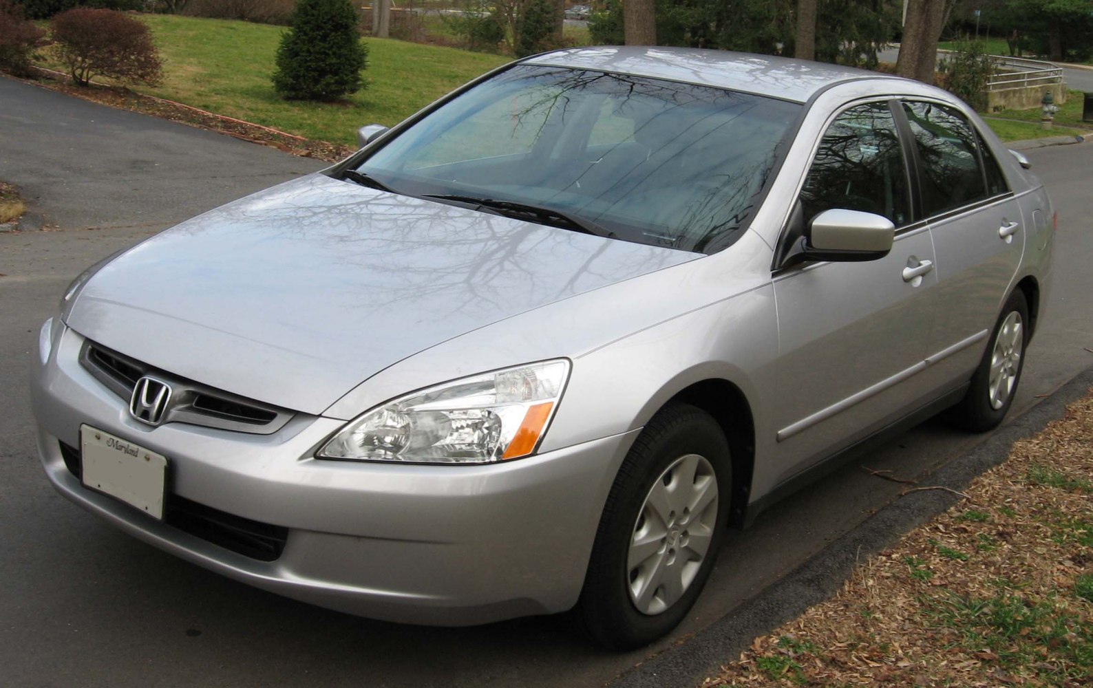 Front angle view of a silver sedan with clear headlights and side mirrors