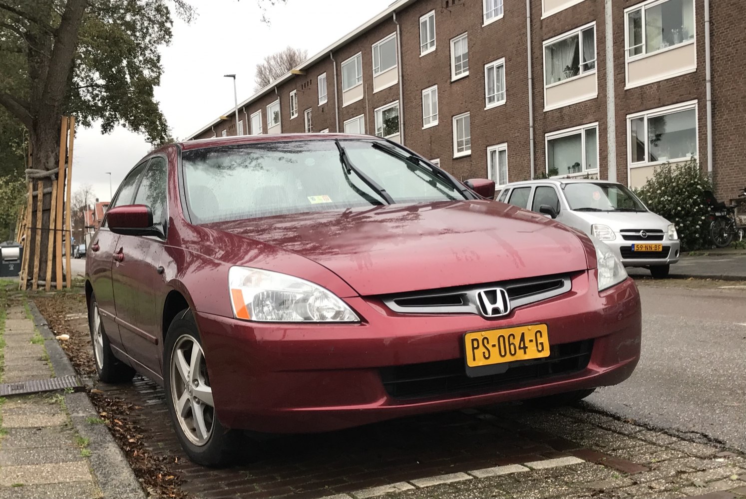 Front view of a red sedan with alloy wheels and clear headlights