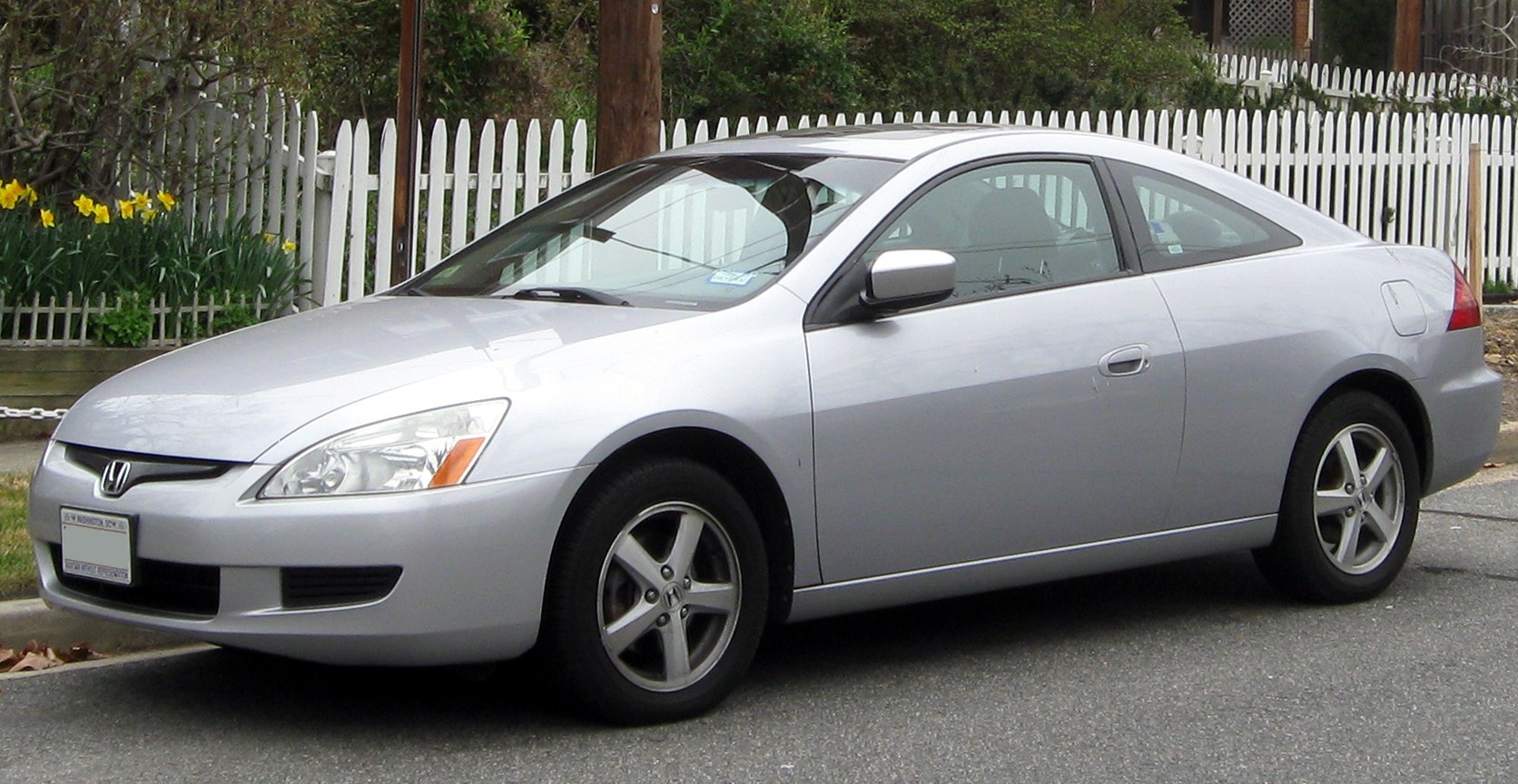 Silver two-door coupe with aerodynamic design and alloy wheels
