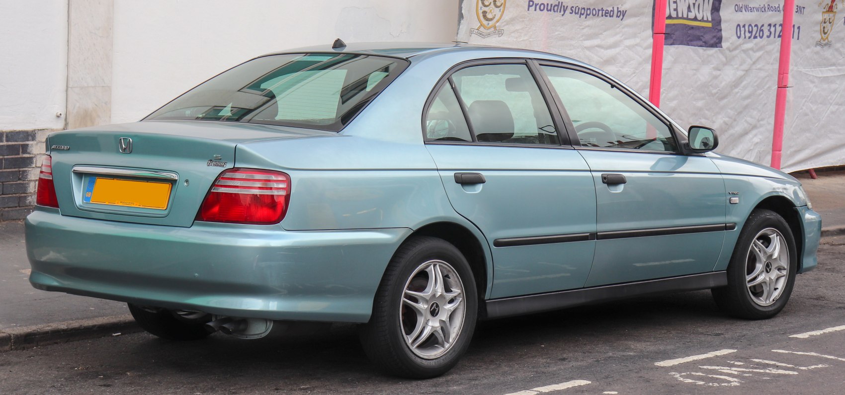 Rear-side view of a four-door sedan with alloy wheels and distinctive taillights