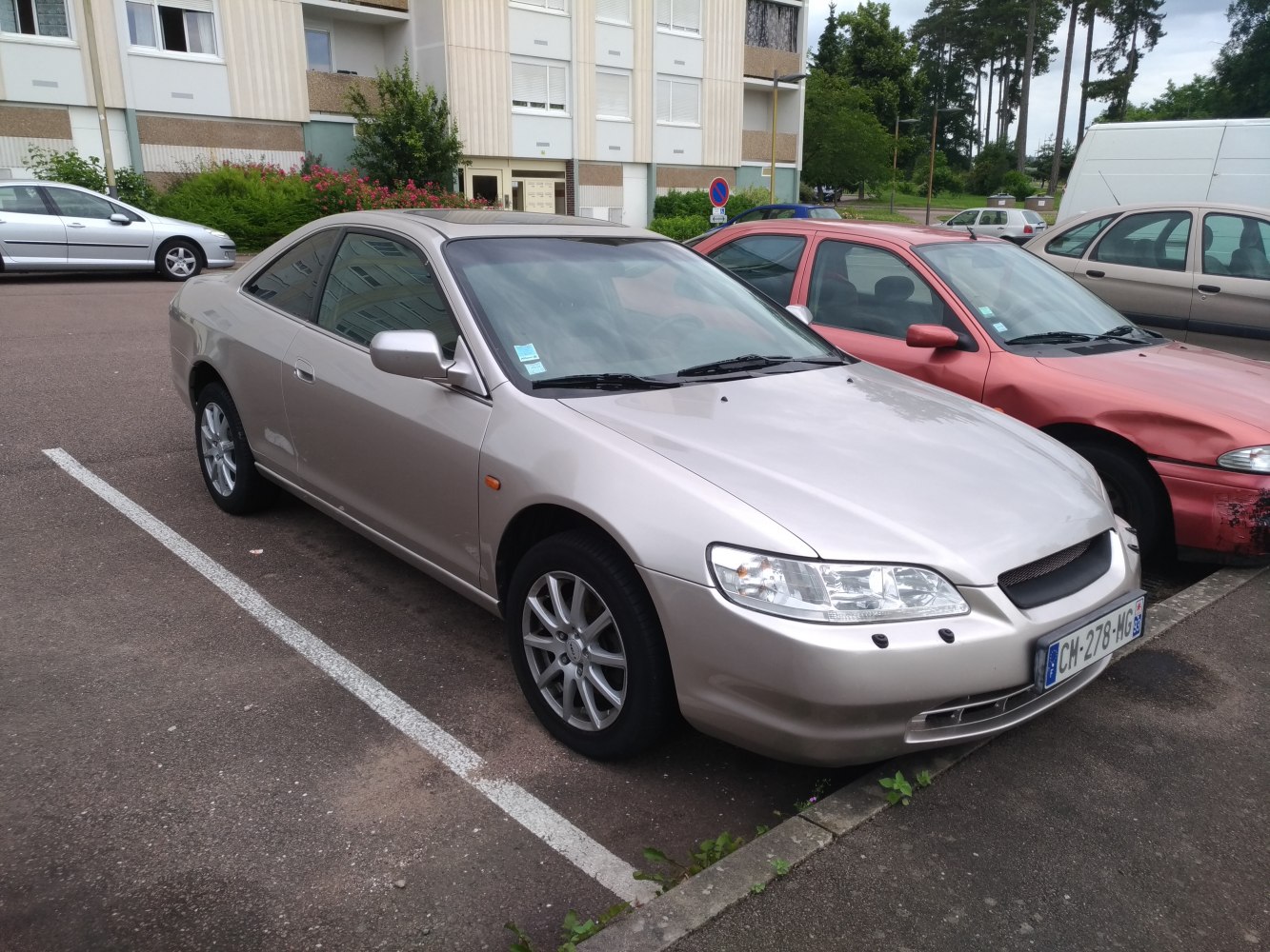 Front side view of a sleek silver two-door coupe from the late 90s.