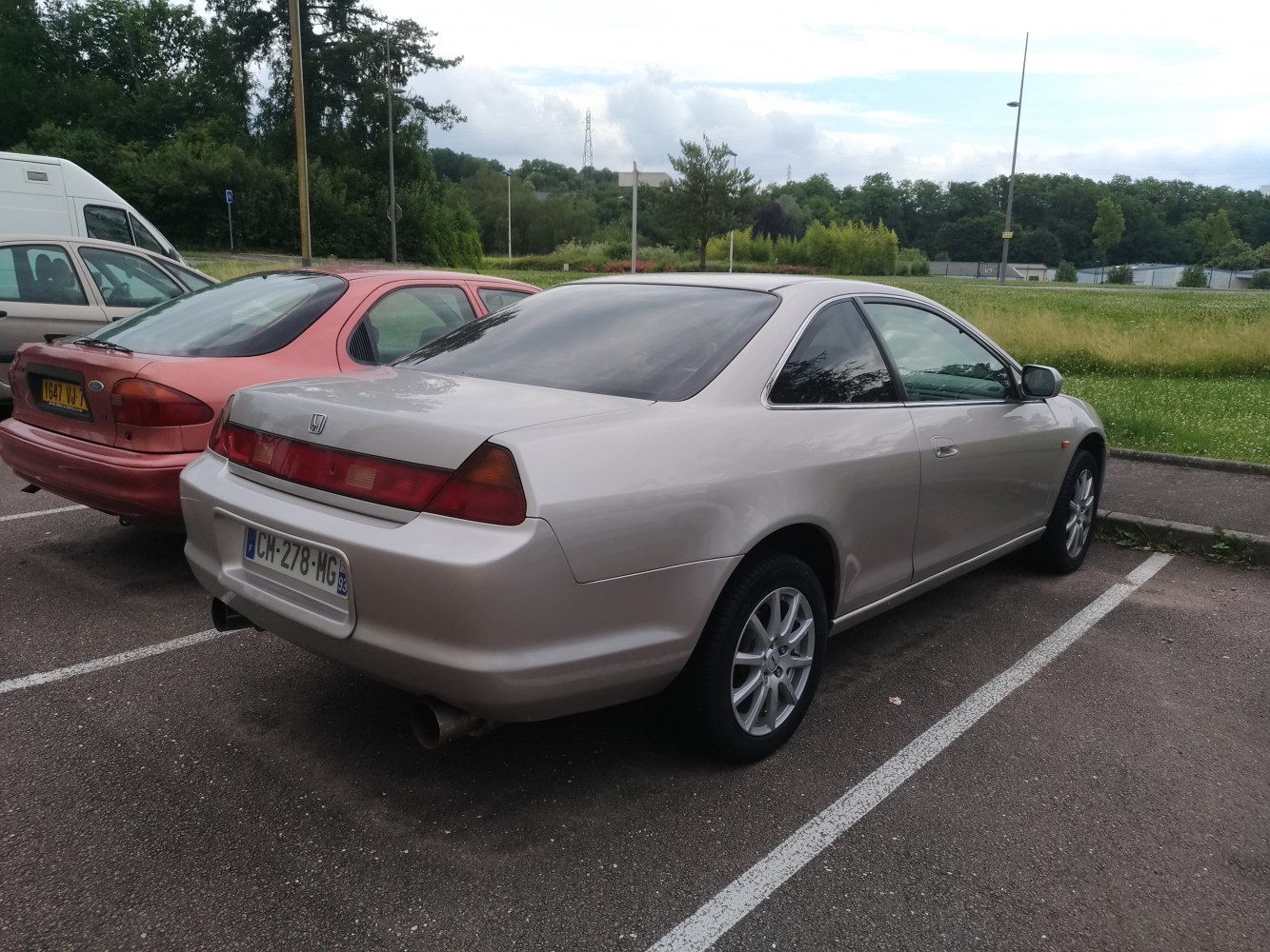 Silver mid-size coupe rear and side view with tinted windows and alloy wheels.