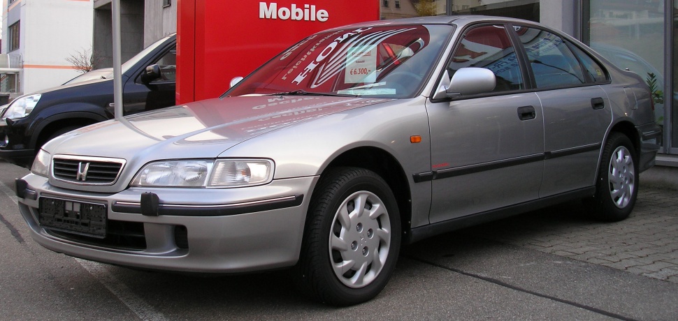Silver sedan with distinct headlights and grille, front-side perspective