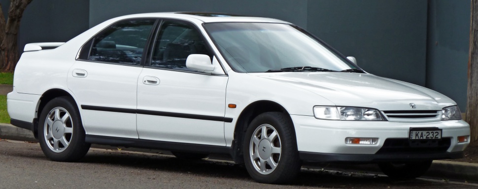 Side view of a white sedan with classic 1990s design