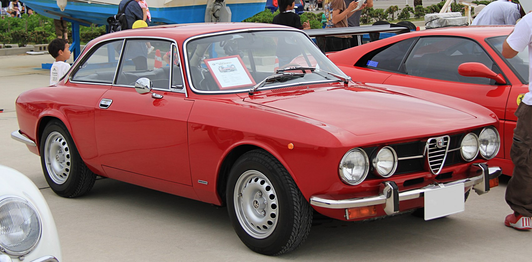 Red sports coupe with quad round headlights and chrome bumpers