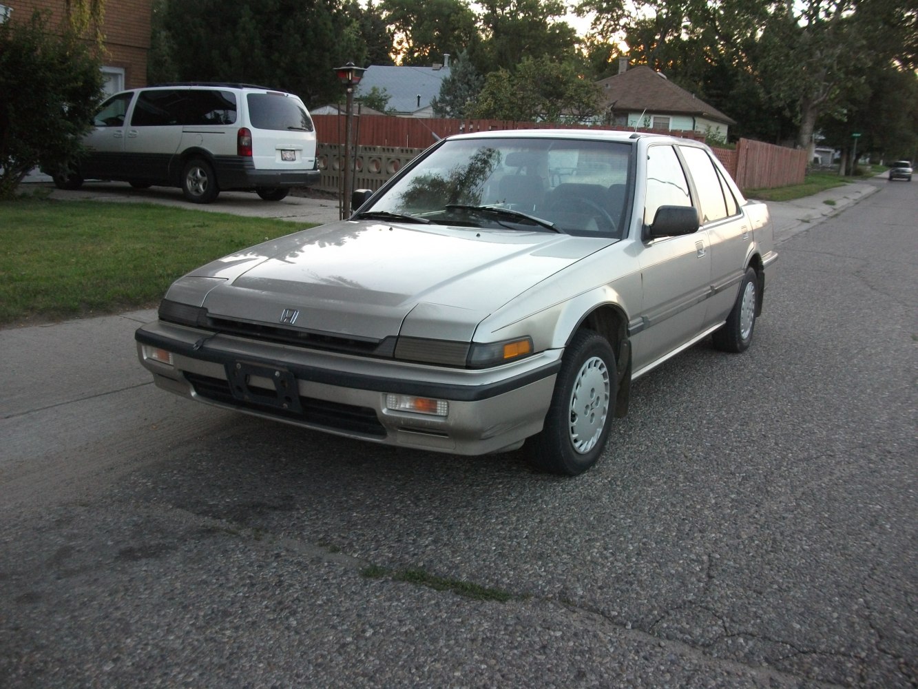 Front side view of 1980s sedan with pop-up headlights