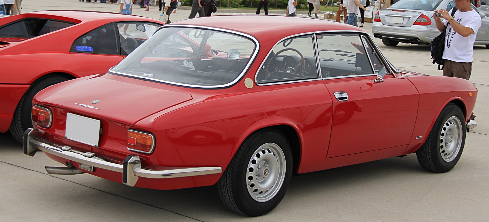 Red vintage coupe rear view with chrome bumpers and round taillights