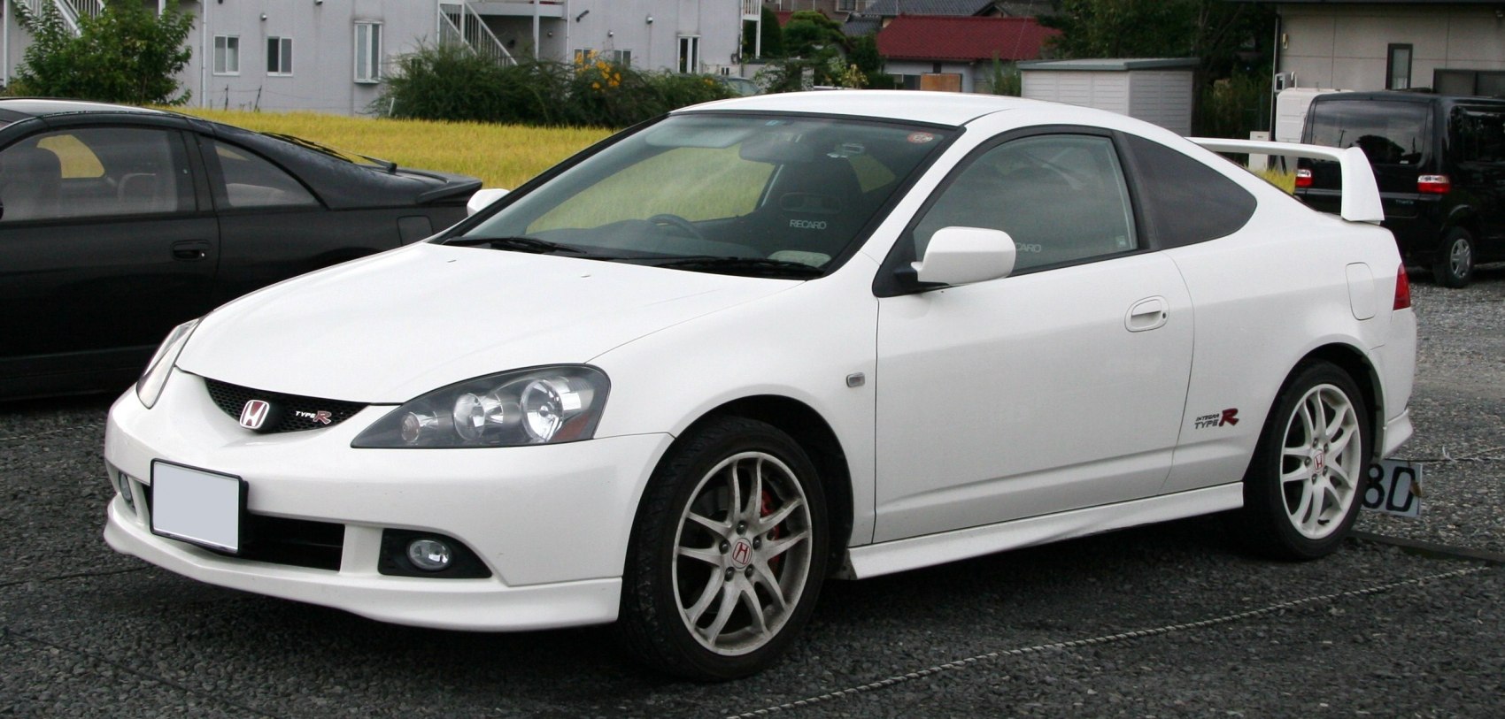 White sporty coupe with rear wing spoiler and performance wheels