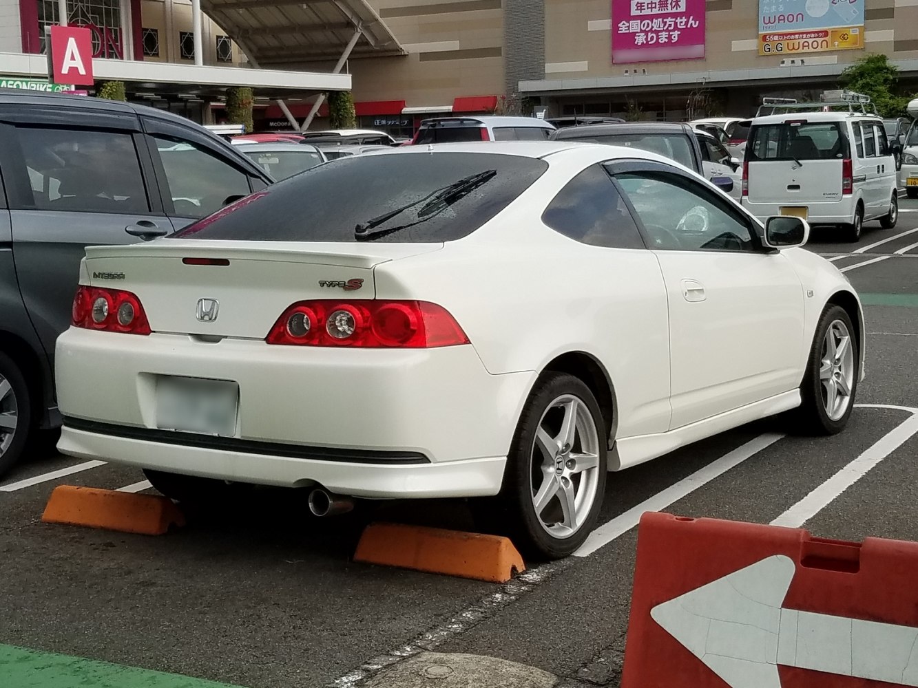 Rear view of a white 2-door sport coupe with distinctive taillights