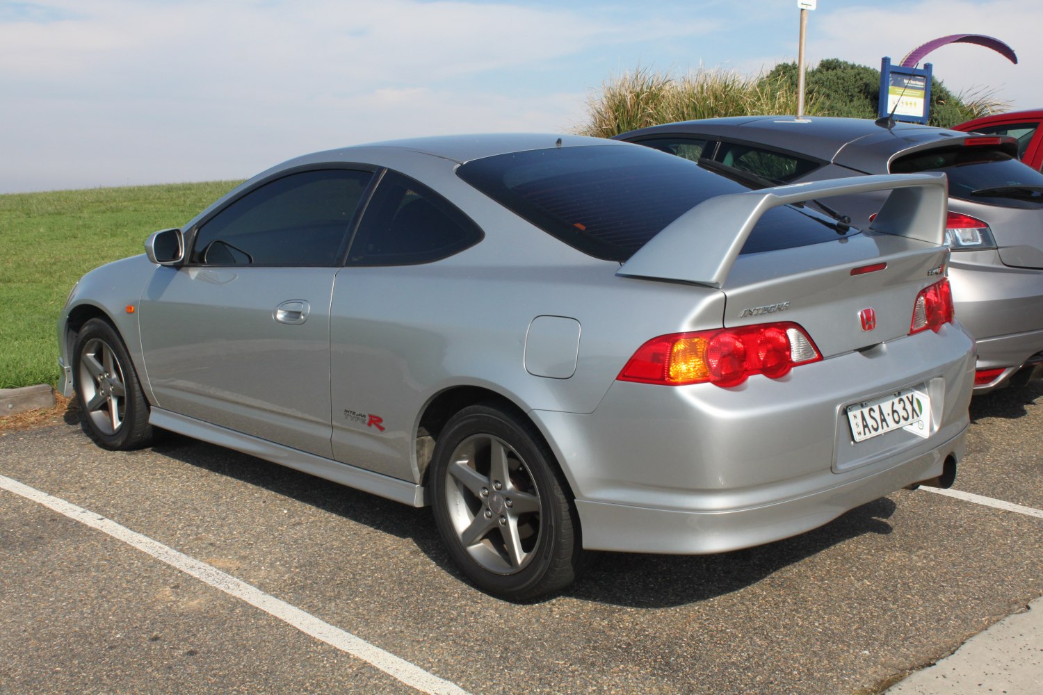 Silver coupe with rear spoiler and five-spoke sport rims