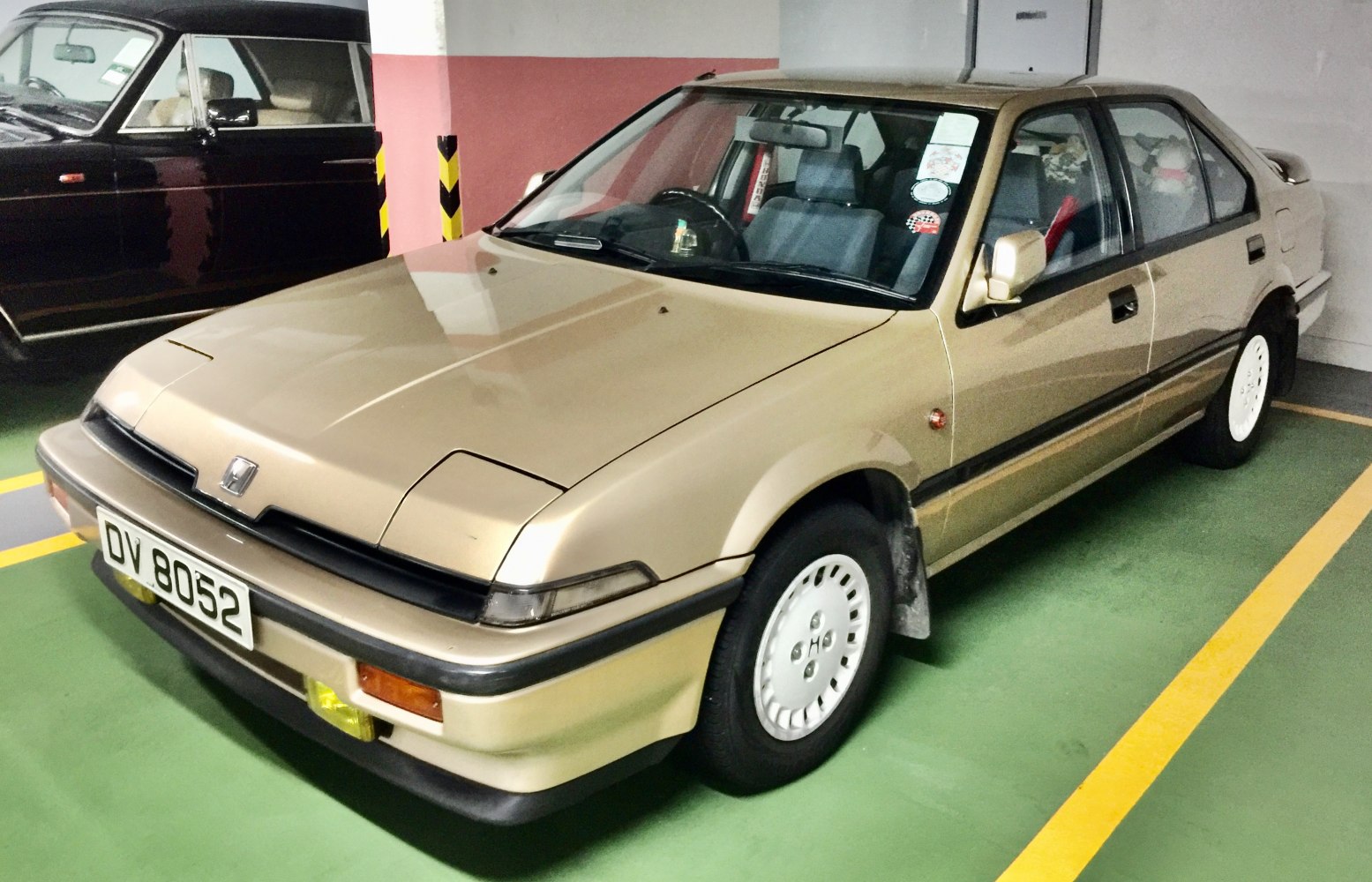 Beige 5-door hatchback with pop-up headlights and white wheels