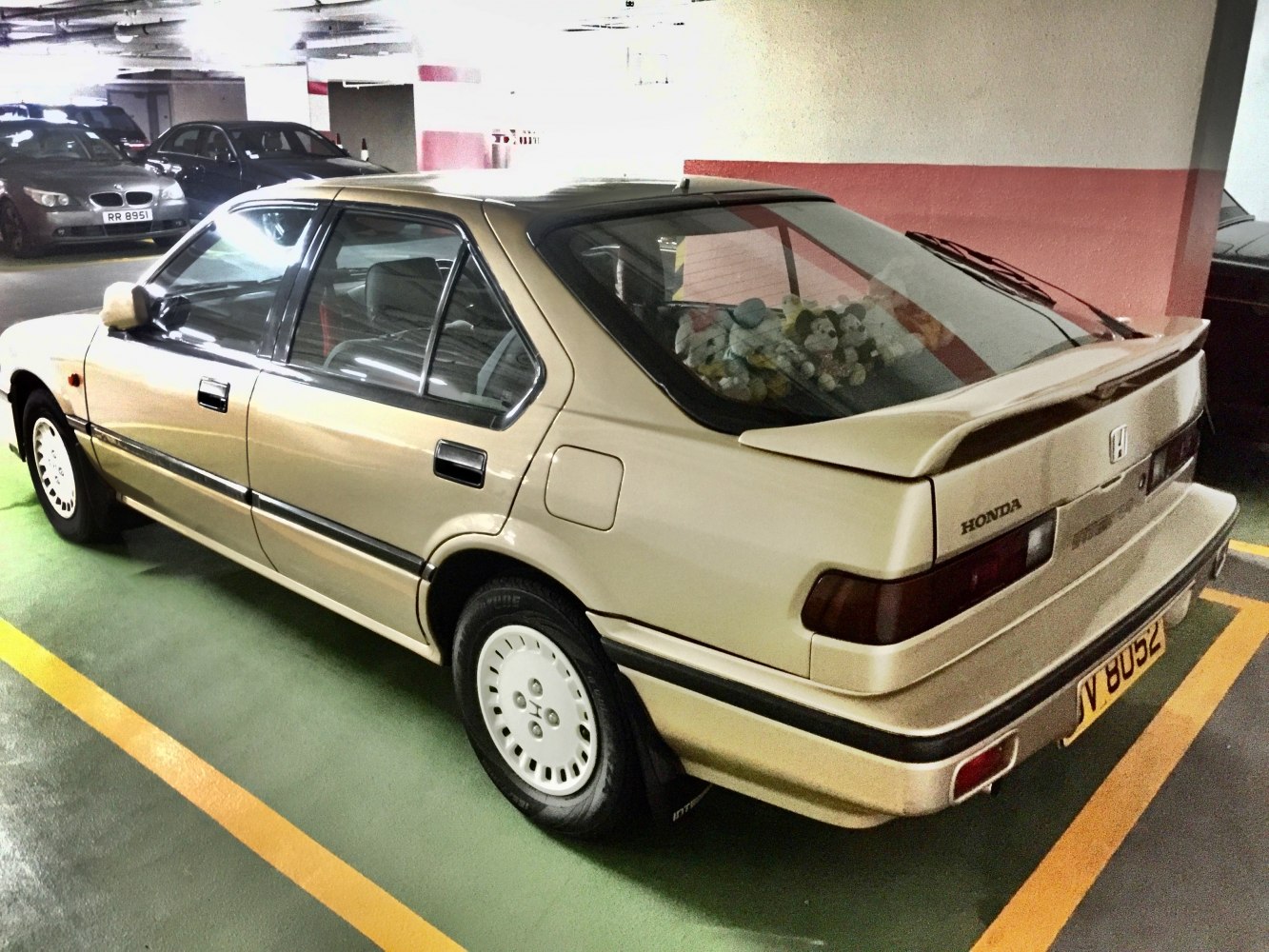 Five-door vintage sedan with rear spoiler and classic wheel rims