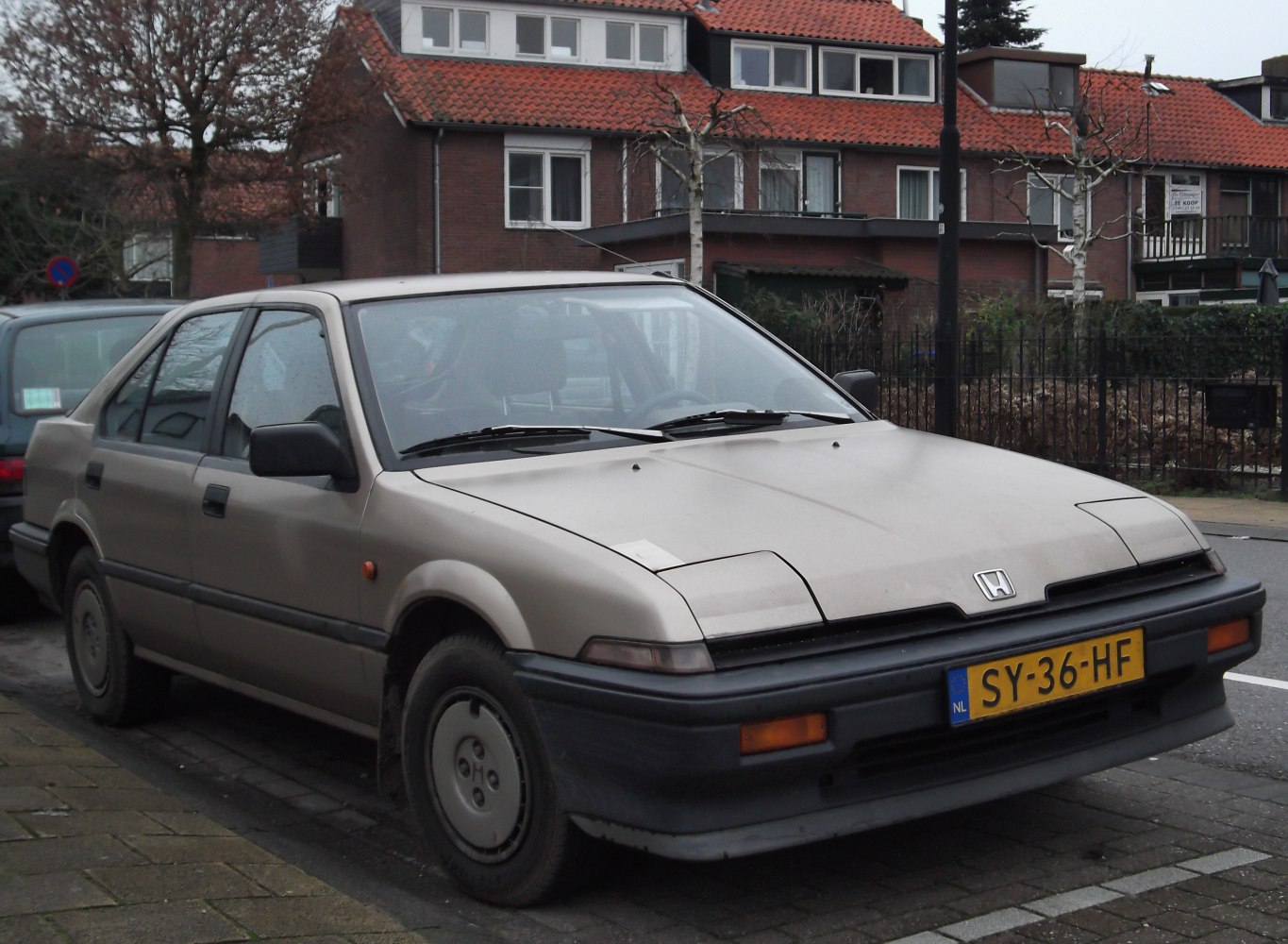 Classic 1980s hatchback with pop-up headlights and 5-door design