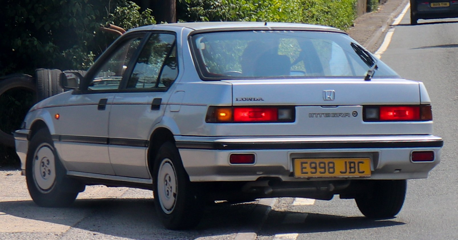 Rear view of a 1980s classic four-door hatchback with distinct tail lights