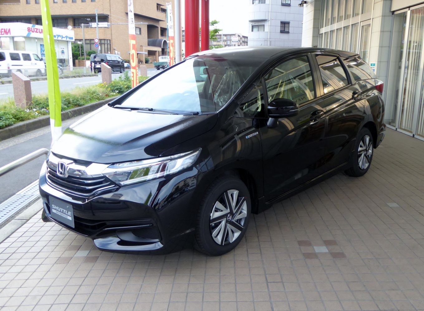 Front-side view of sleek hybrid compact wagon with aerodynamic design