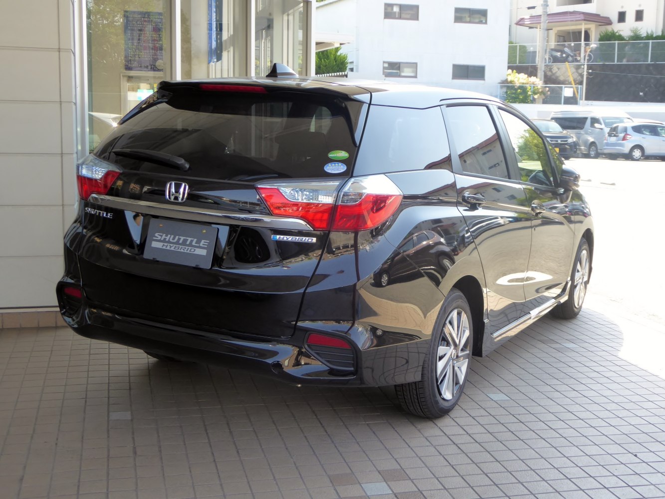 Rear-angle view of hybrid compact wagon with distinct taillights and rear windshield wiper