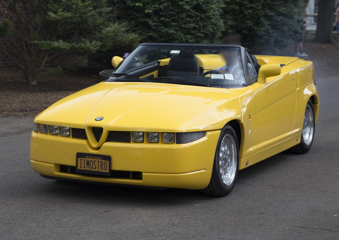 Yellow convertible sports car with angular front and pop-up headlights