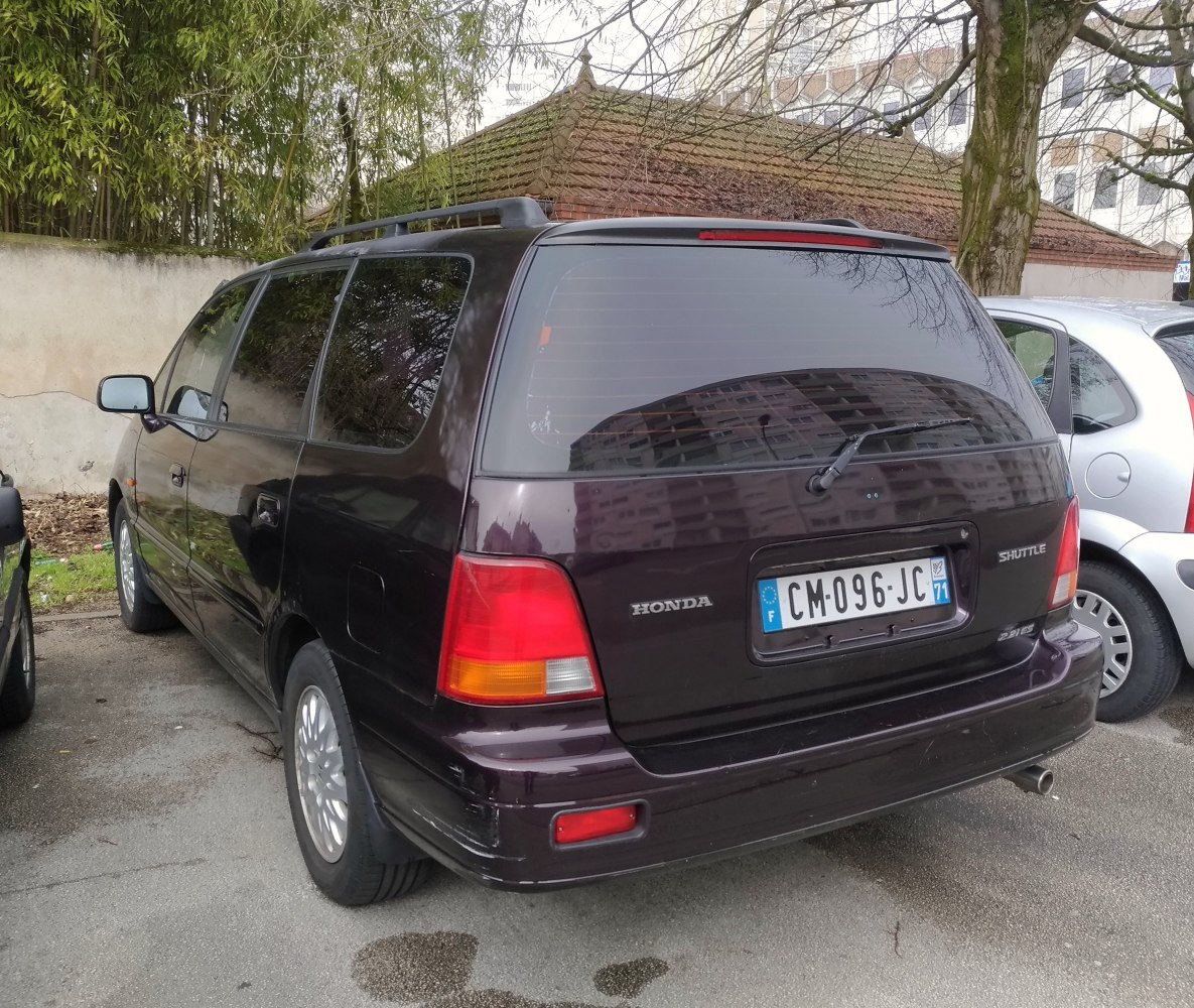 Rear view of a station wagon with roof rails and tinted windows