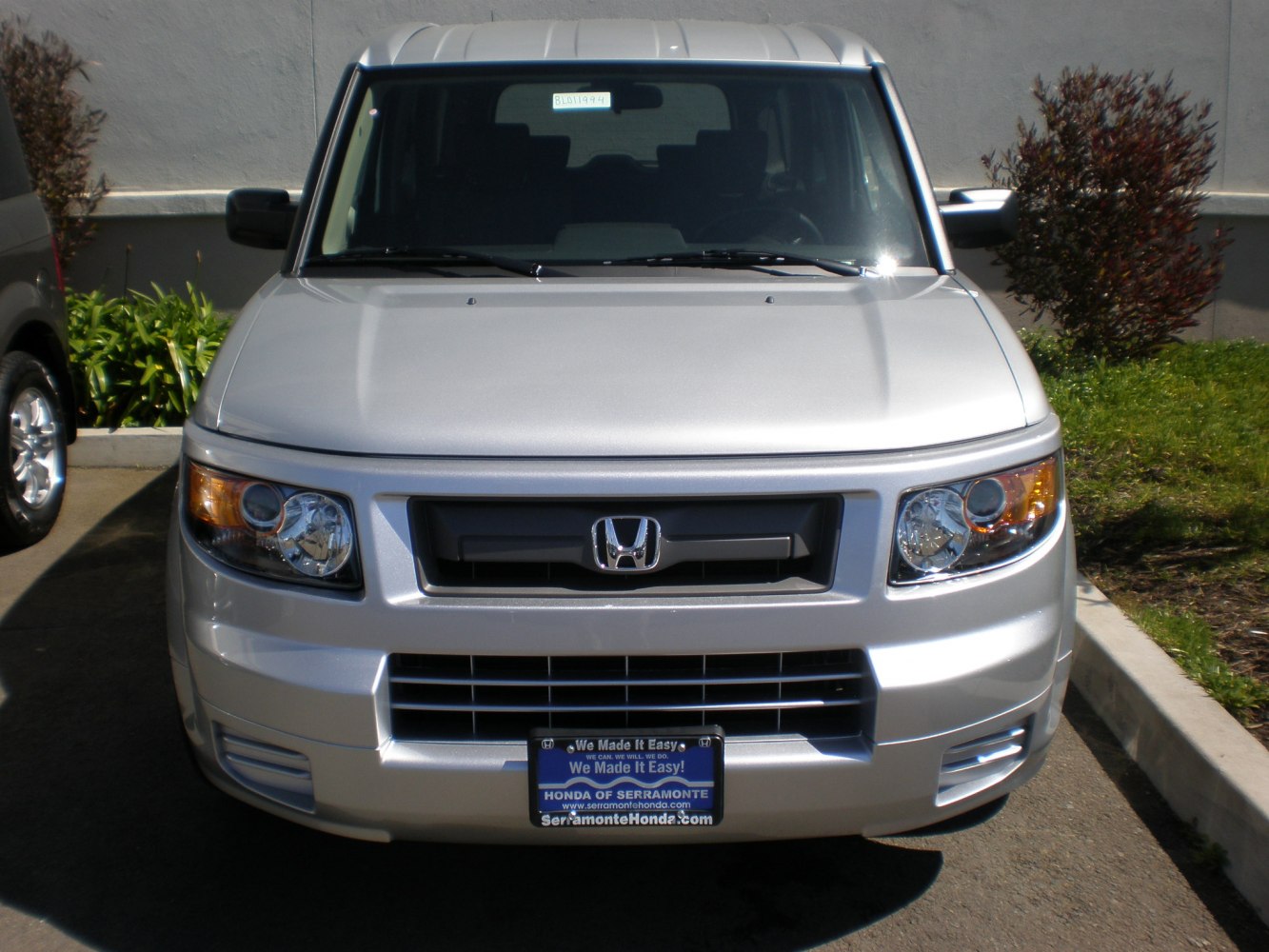 Silver front view with distinctive headlights and grille design