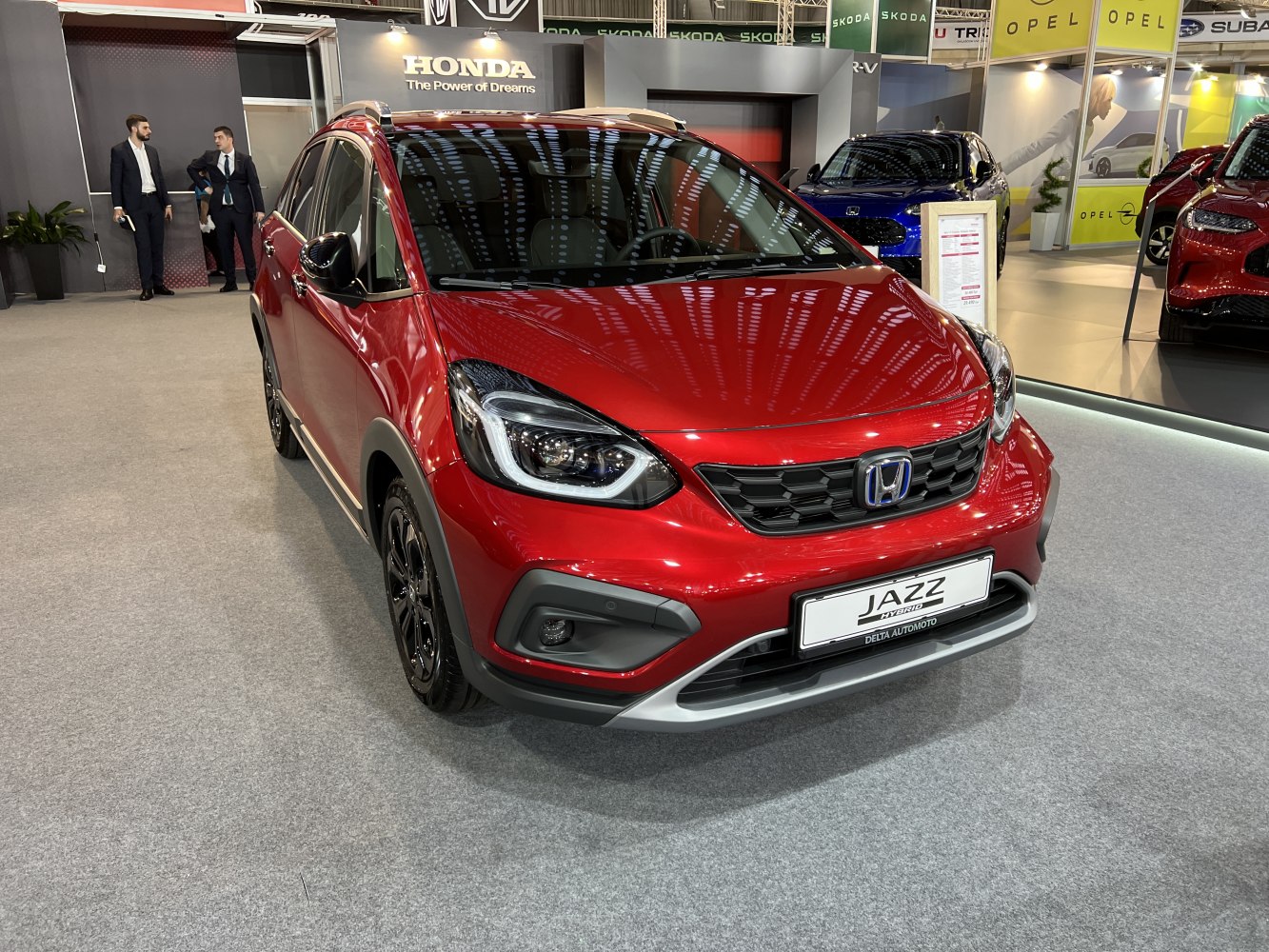 Red compact hatchback front view with LED headlights