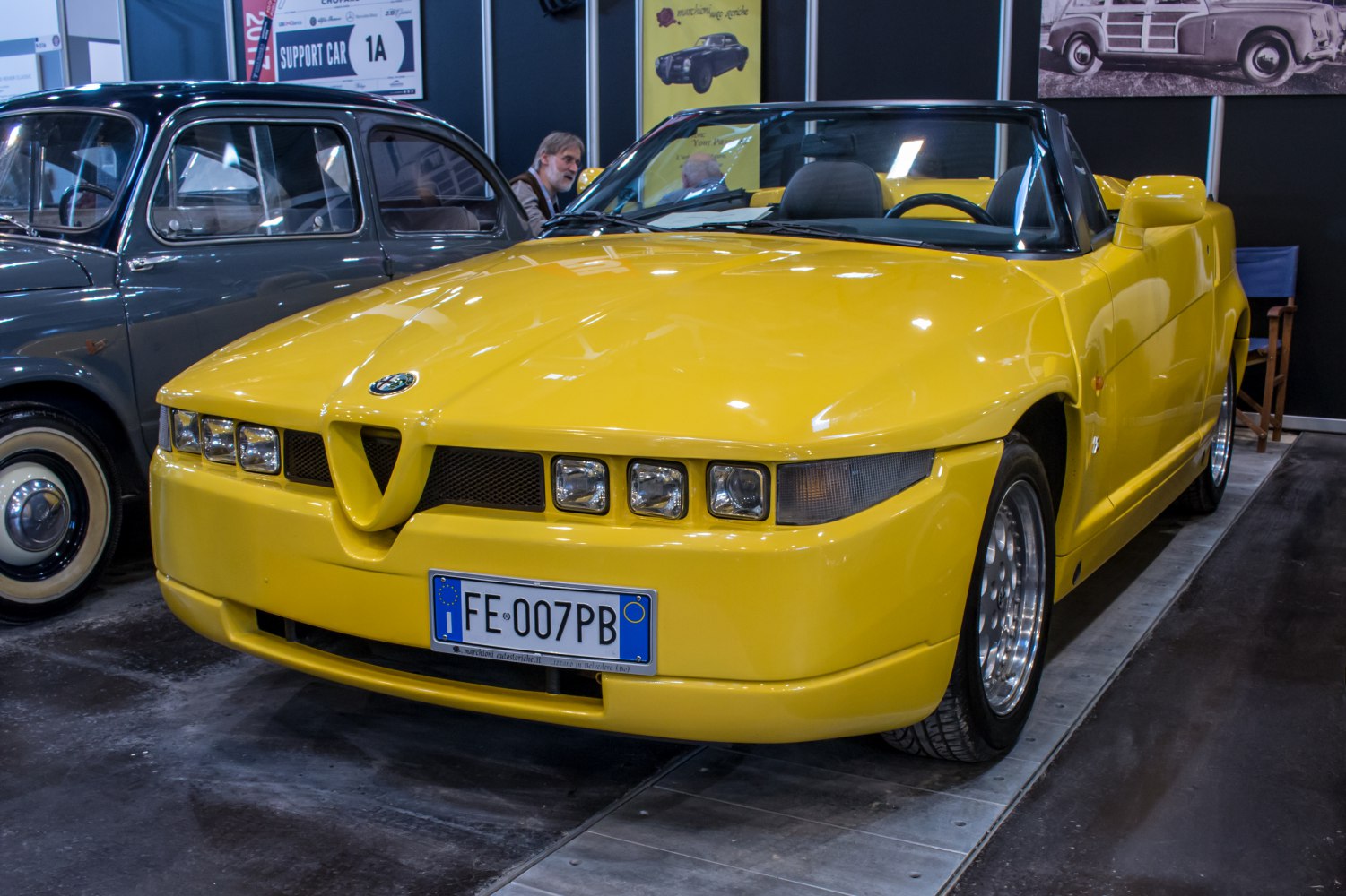 Yellow convertible sports car with quad headlights and distinct front grille