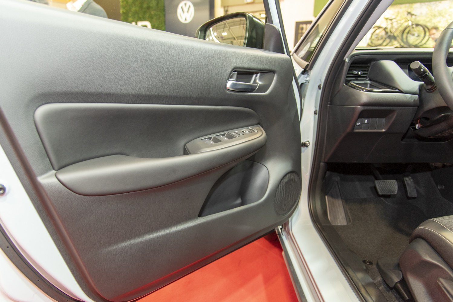 Driver side interior door panel with controls and speaker