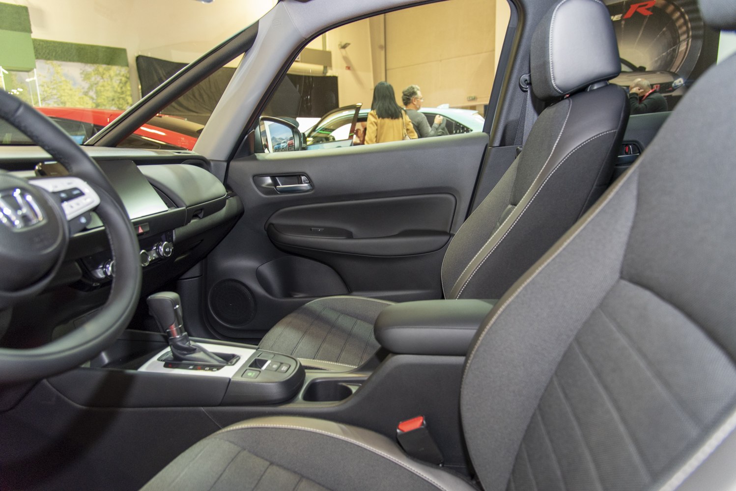 Compact car interior with fabric seats and modern dashboard.