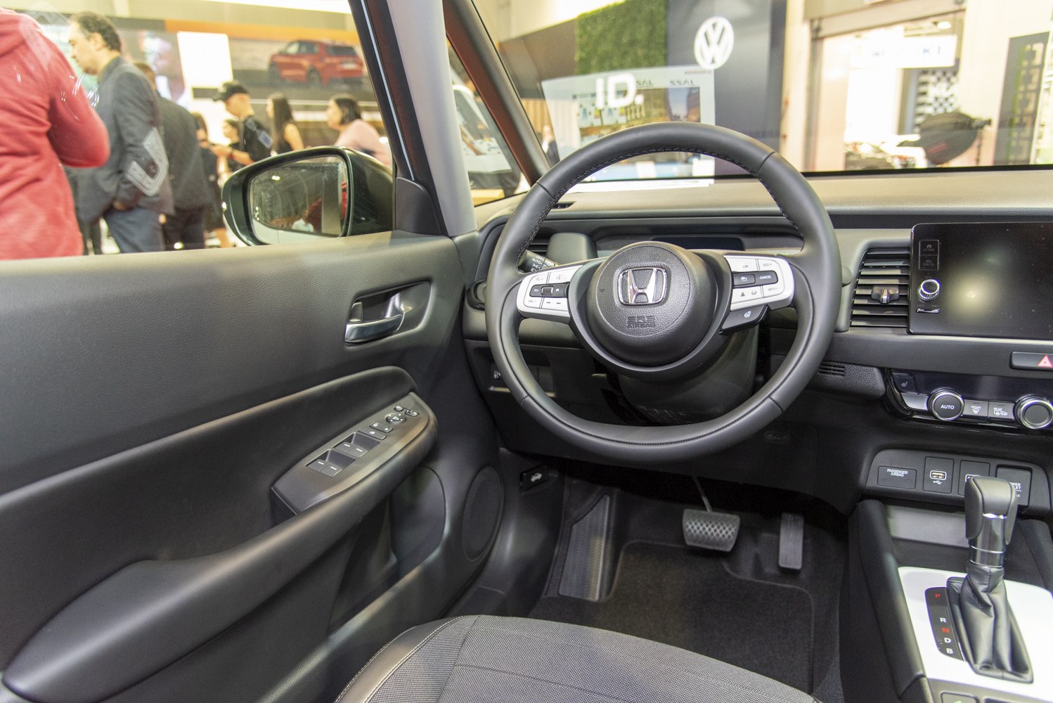 Steering wheel and dashboard interior with gear shift and control buttons